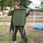 Olive Green Tzitzit An olive green tallit katan with white tzitzit